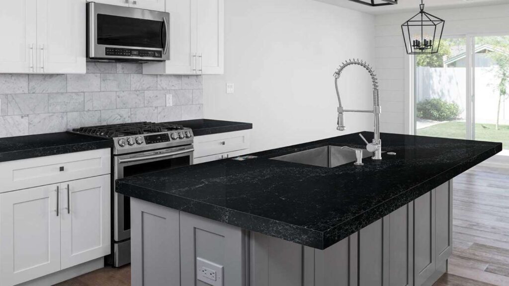 Black quartz countertop with white cabinet 