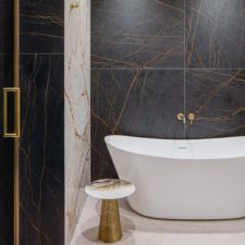 Dekton Laurent Bathroom Wall with Gold color shower and faucet